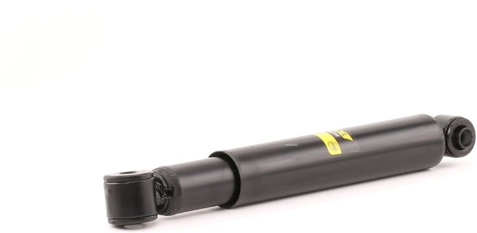 Black hydraulic shock absorber lying on a white background, showing its end mounts and yellow label.