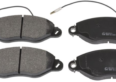 Four disc brake pads with wear-sensor cables for a vehicle (front and rear set).