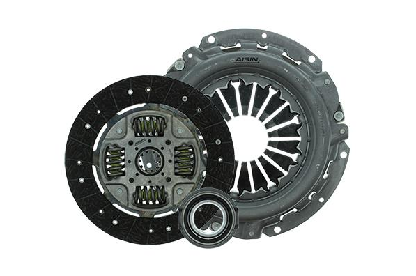 Automotive clutch kit with pressure plate, clutch disc, and release bearing laid out together.